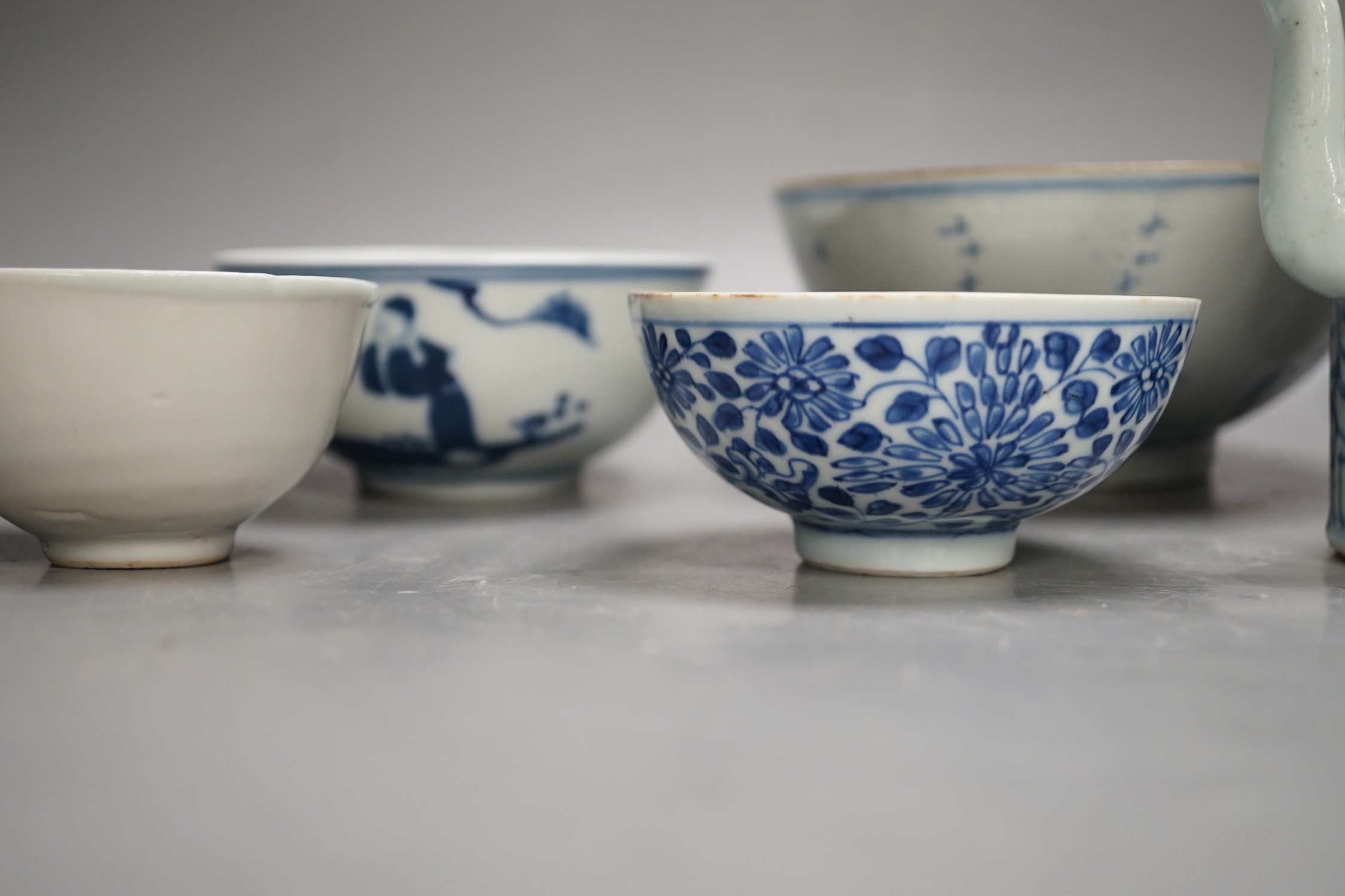 A Chinese Ming dynasty internally decorated porcelain tea bowl, an 18th century blue and white bowl, two other blue and white bowls, a similar water pot and an Islamic brass vessel